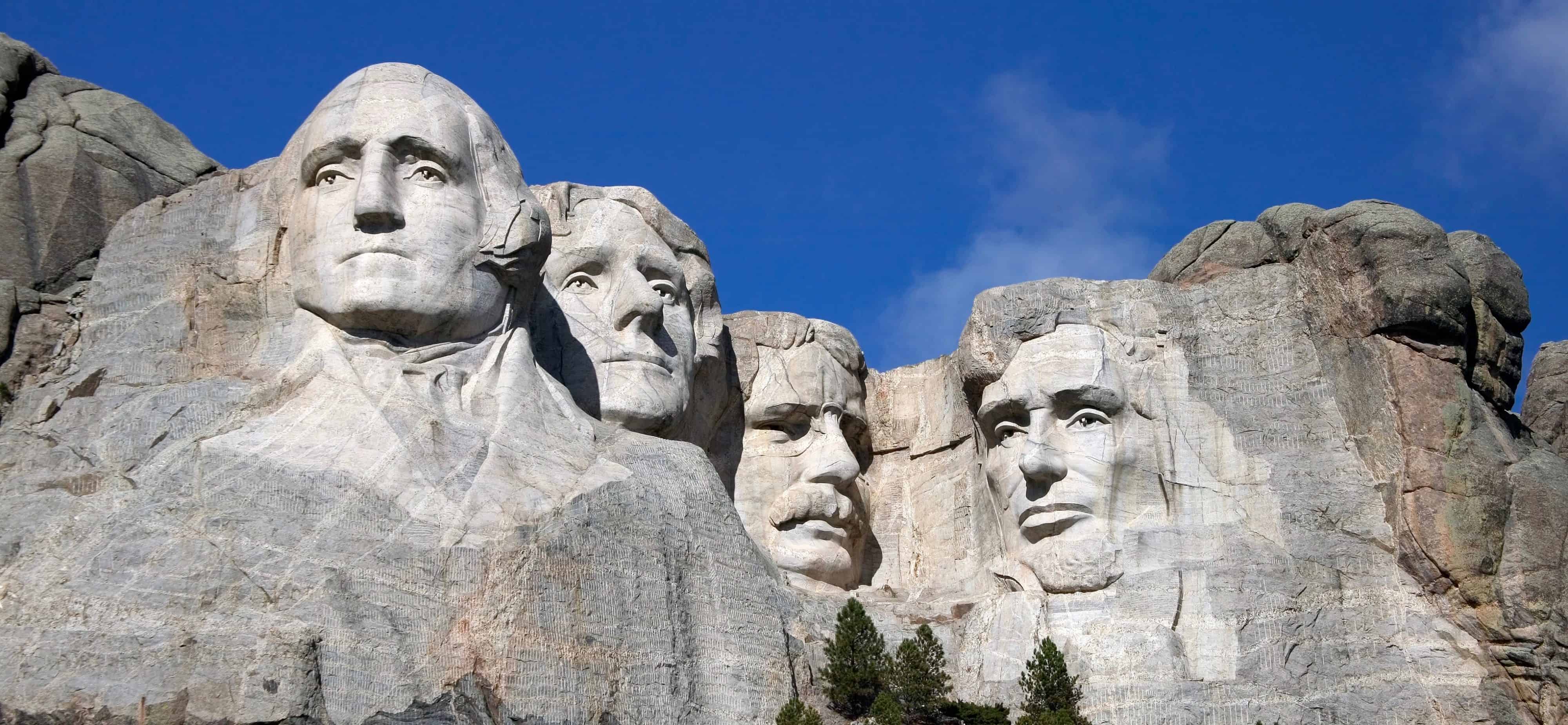 Close up view of Mount Rushmore under a blue sky